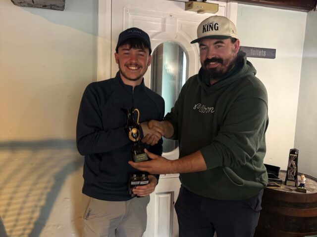 A golf society member handed his trophy in the bar