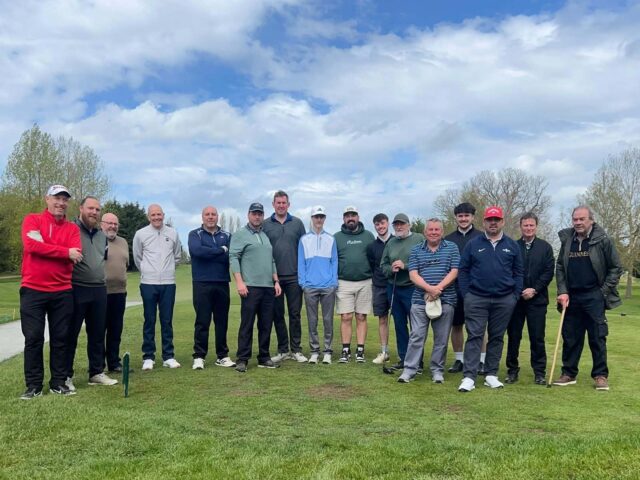 The Horseshoe Golf Society lined up on the course on a sunny day