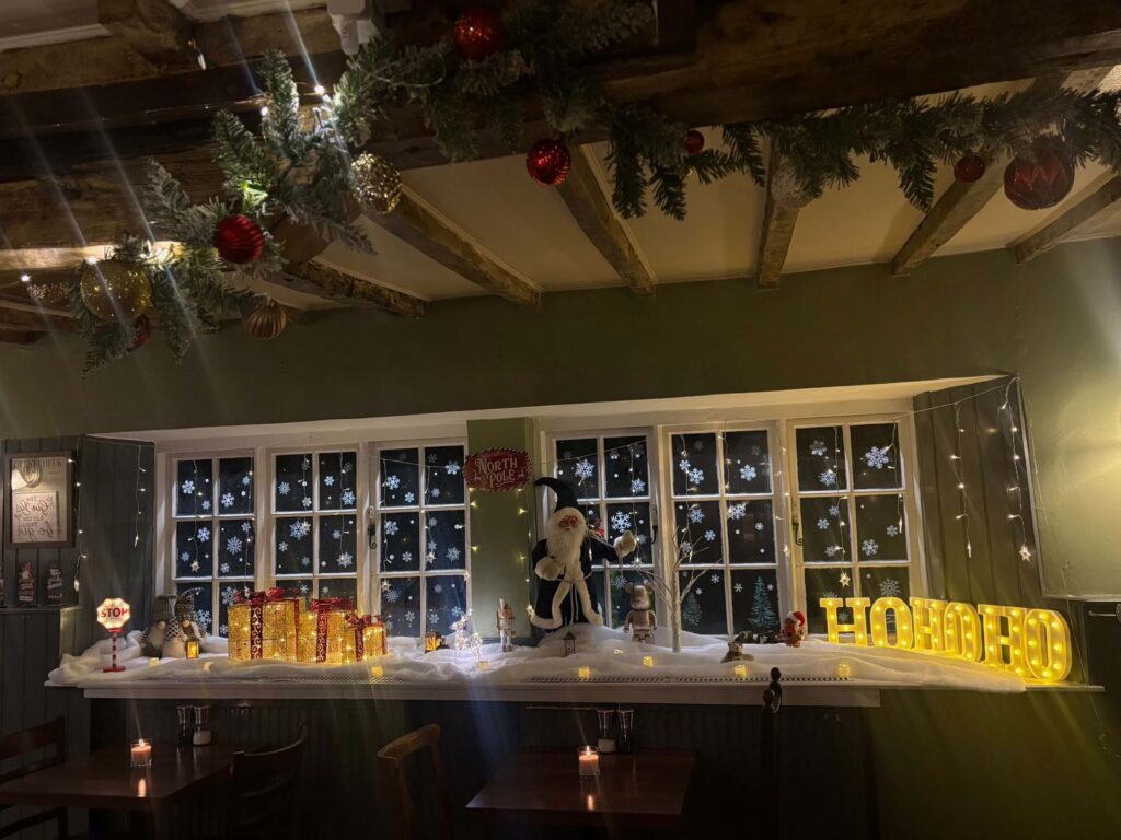 The windows dressed for Christmas, with HO HO HO in lights