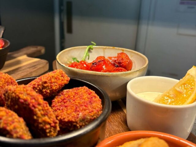 Crispy small plates with lemon and a pot of dip