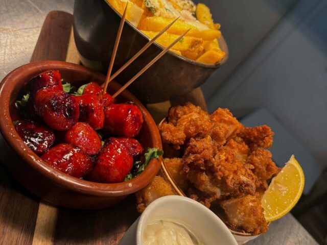 A board of small plates with a pot of lemon mayo